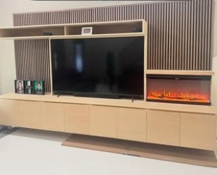Custom slatted media wall with a built-in fireplace